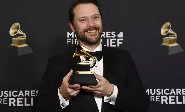 Jason Carter poses in the press room with the award for best audiobook, narration, and storytelling recording for "Last Sundays in Plains: A Centennial Celebration", after accepting on behalf of his father Jimmy Carter during the 67th annual Grammy Awards on Sunday, Feb. 2, 2025, in Los Angeles. (Photo by Richard Shotwell/Invision/AP)