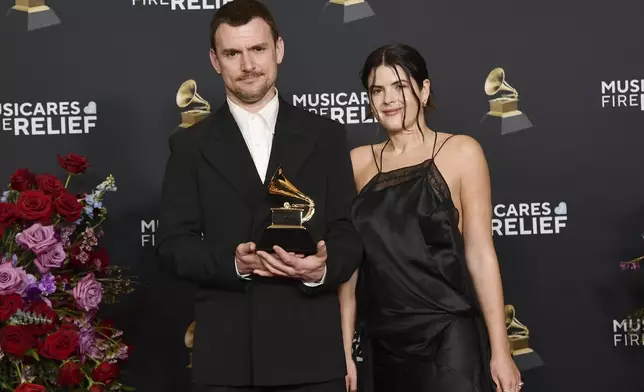 Brent David Freaney, left, and Imogene Strauss, winners of the award for best recording package for Charli xcx's "BRAT" pose in the press room during the 67th annual Grammy Awards on Sunday, Feb. 2, 2025, in Los Angeles. (Photo by Richard Shotwell/Invision/AP)