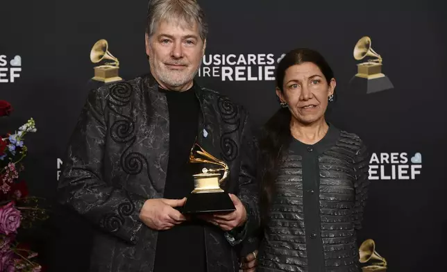 Bela Fleck, left, and Liana Corea pose in the press room after accepting the best jazz instrumental album award for "Rememberance", during the 67th annual Grammy Awards on Sunday, Feb. 2, 2025, in Los Angeles. (Photo by Richard Shotwell/Invision/AP)