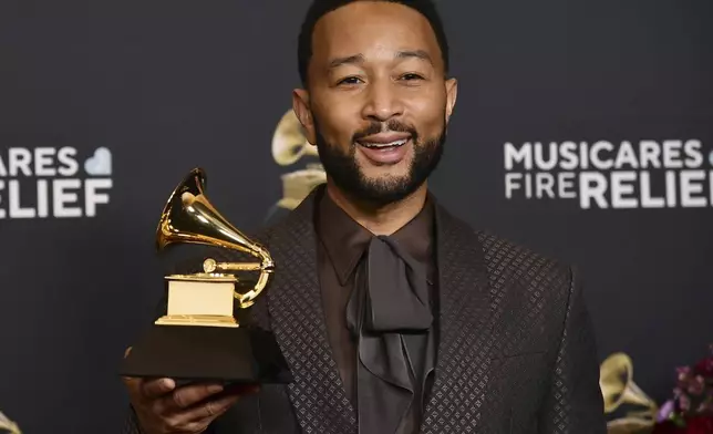 John Legend poses in the press room with the award for best arrangement, instrumental or a cappella during the 67th annual Grammy Awards on Sunday, Feb. 2, 2025, in Los Angeles. (Photo by Richard Shotwell/Invision/AP)