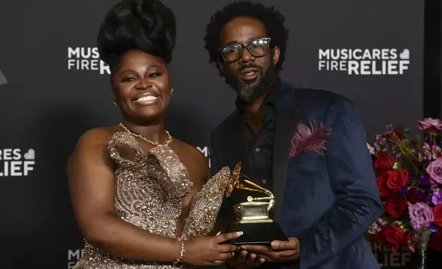 Tarriona 'Tank' Ball, left,and Norman Spence, of Tank and the Bangas pose in the press room with the award for best spoken word poetry album during the 67th annual Grammy Awards on Sunday, Feb. 2, 2025, in Los Angeles. (Photo by Richard Shotwell/Invision/AP)