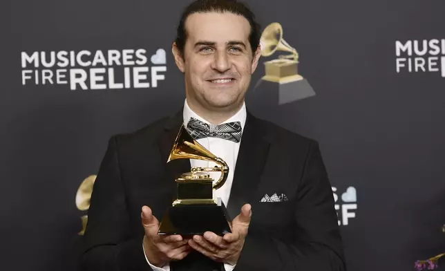 Dan Pugach of Dan Pugach Big Band, winner of the award for best large jazz ensemble album for "Bianca Reimagined: Music for Paws and Persistence" poses in the press room during the 67th annual Grammy Awards on Sunday, Feb. 2, 2025, in Los Angeles. (Photo by Richard Shotwell/Invision/AP)