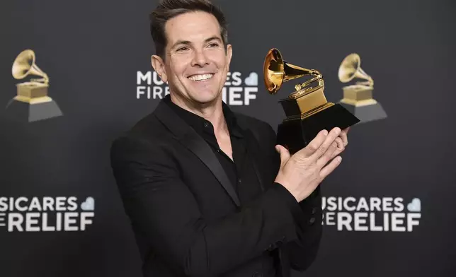 Steven Gizicki poses in the press room with the award for best compilation soundtrack for visual media for "Maestro: Music By Leonard Bernstein" during the 67th annual Grammy Awards on Sunday, Feb. 2, 2025, in Los Angeles. (Photo by Richard Shotwell/Invision/AP)