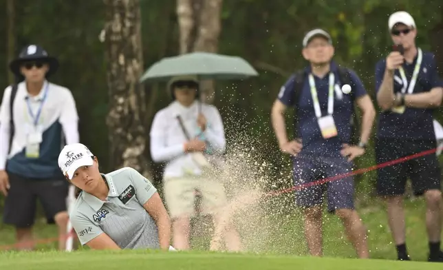 Jin Young Ko of South Korea hits out of a bunker on the 8th green during the first round of the LPGA Honda Thailand golf tournament in Pattaya, southern Thailand, Thursday, Feb. 20, 2025. (AP Photo/Kittinun Rodsupan)