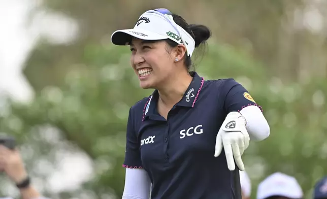 Atthaya Thitikul of Thailand reacts after playing on the 1st hole during the first round of the LPGA Honda Thailand golf tournament in Pattaya, southern Thailand, Thursday, Feb. 20, 2025. (AP Photo/Kittinun Rodsupan)