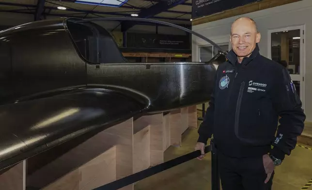 Swiss aviation pioneer Bertrand Piccard poses for a photo in front of the Climate Impulse, a plane powered by liquid hydrogen, at a hangar in Les Sables d'Olonne, France on Thursday, Feb. 13, 2025.(AP Photo/Yohan Bonnet)