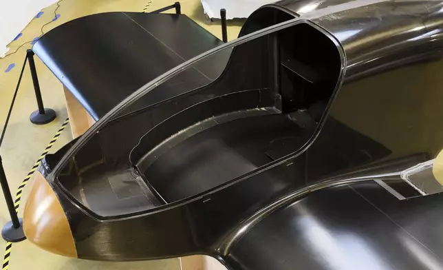 The Climate Impulse, a plane powered by liquid hydrogen, is displayed at a hangar in Les Sables d'Olonne, France on Thursday, Feb. 13, 2025. (AP Photo/Yohan Bonnet)