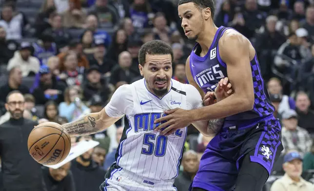 Orlando Magic guard Cole Anthony (50) drives past Sacramento Kings forward Keegan Murray during the first half of an NBA basketball game in Sacramento, Calif., Wednesday, Feb. 5, 2025. (AP Photo/Randall Benton)