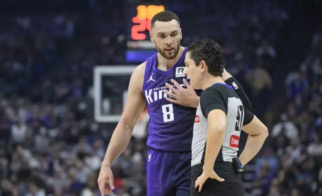 Sacramento Kings guard Zach LaVine (8) discusses an official's call with referee Cheryl Flores during the first half of an NBA basketball game against the Orlando Magic in Sacramento, Calif., Wednesday, Feb. 5, 2025. (AP Photo/Randall Benton)