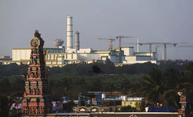 A temple stands in the foreground of the Madras Atomic Power Station located at Kalpakkam in the Indian state of Tamil Nadu, Monday, Feb. 10, 2025. (AP Photo/R. Parthibhan)