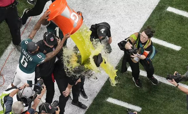 Philadelphia Eagles wide receiver DeVonta Smith (6) dunks head coach Nick Sirianni during the second half of the NFL Super Bowl 59 football game against the Kansas City Chiefs, Sunday, Feb. 9, 2025, in New Orleans. (AP Photo/David J. Phillip)