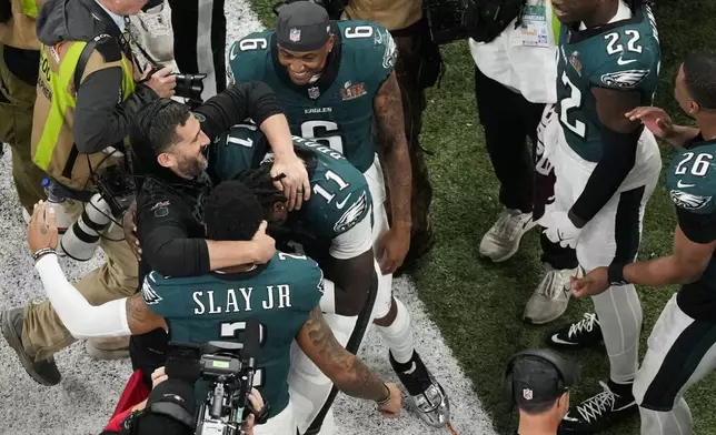 Philadelphia Eagles head coach Nick Sirianni, left, is hugged by wide receiver A.J. Brown (11) and cornerback Darius Slay Jr. (2) during the second half of the NFL Super Bowl 59 football game against the Kansas City Chiefs, Sunday, Feb. 9, 2025, in New Orleans. (AP Photo/Godofredo A. Vásquez)