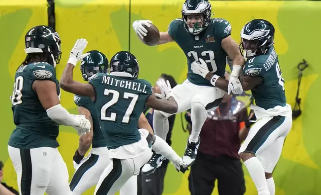 Philadelphia Eagles defensive back Cooper DeJean (33) celebrate his touchdown with safety C.J. Gardner-Johnson (8) after an interception against the Kansas City Chiefs during the first half of the NFL Super Bowl 59 football game, Sunday, Feb. 9, 2025, in New Orleans. (AP Photo/Frank Franklin II)