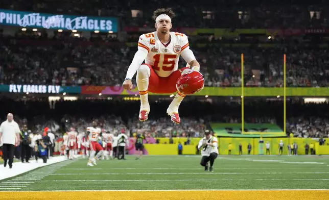 Kansas City Chiefs quarterback Patrick Mahomes (15) jumps prior to the NFL Super Bowl 59 football game against the Philadelphia Eagles, Sunday, Feb. 9, 2025, in New Orleans. (AP Photo/Ashley Landis)