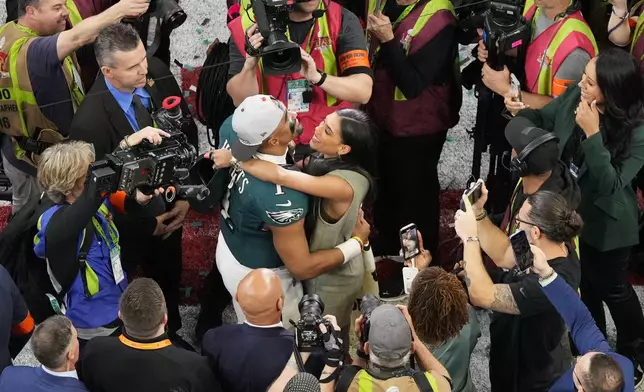 Philadelphia Eagles quarterback Jalen Hurts (1) hugs his partner Bryonna Burrows after the NFL Super Bowl 59 football game, Sunday, Feb. 9, 2025, in New Orleans. (AP Photo/Godofredo A. V·squez)