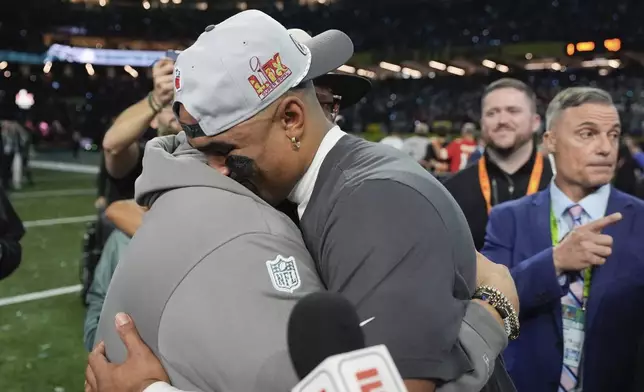Philadelphia Eagles quarterback Jalen Hurts hugs his father Averion Hurts after the Eagles defeated the Kansas City Chiefs in the NFL Super Bowl 59 football game, Sunday, Feb. 9, 2025, in New Orleans. (AP Photo/George Walker IV)