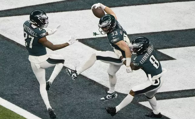 Philadelphia Eagles defensive back Cooper DeJean (33) celebrates after returning an interception for a touchdown against the Kansas City Chiefs during the first half of the NFL Super Bowl 59 football game, Sunday, Feb. 9, 2025, in New Orleans. (AP Photo/Charlie Riedel)