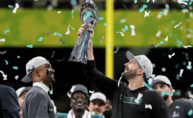 Philadelphia Eagles head coach Nick Sirianni, right, lifts the Vince Lombardi Trophy next to quarterback Jalen Hurts after defeating the Kansas City Chiefs in the NFL Super Bowl 59 football game, Sunday, Feb. 9, 2025, in New Orleans. (AP Photo/Matt Slocum)