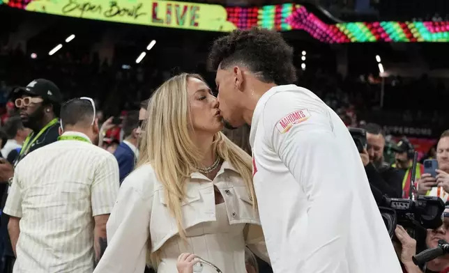 Kansas City Chiefs quarterback Patrick Mahomes kisses his wife, Brittany Mahomes prior to the NFL Super Bowl 59 football game against the Philadelphia Eagles, Sunday, Feb. 9, 2025, in New Orleans. (AP Photo/Brynn Anderson)