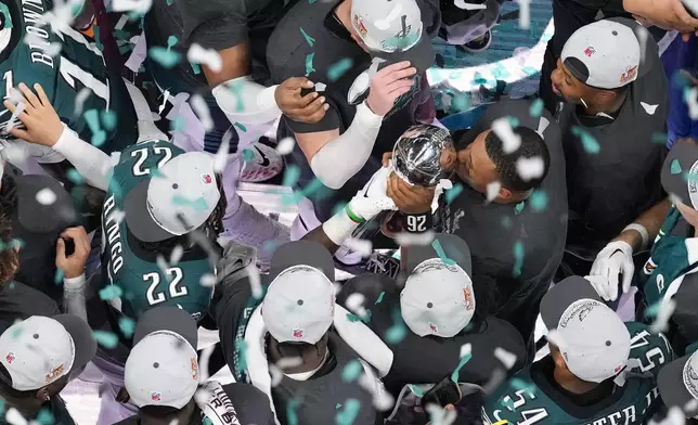 Philadelphia Eagles running back Saquon Barkley (26) kisses the Vince Lombardi Trophy after the Eagles won the NFL Super Bowl 59 football game against the Kansas City Chiefs, Sunday, Feb. 9, 2025, in New Orleans. (AP Photo/David J. Phillip)