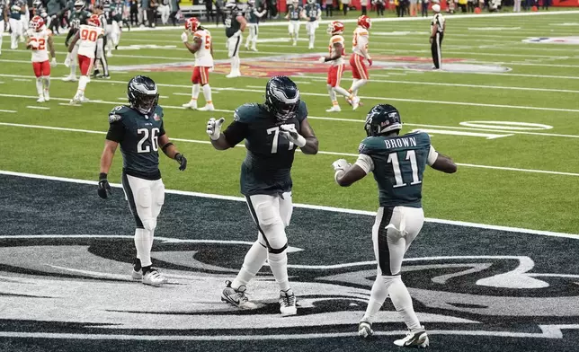 Philadelphia Eagles wide receiver A.J. Brown (11) dances with offensive tackle Mekhi Becton (77) after Brown's touchdown reception during the first half of the NFL Super Bowl 59 football game against the Kansas City Chiefs, Sunday, Feb. 9, 2025, in New Orleans. (AP Photo/Stephanie Scarbrough)