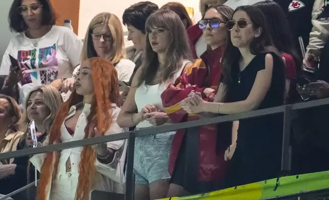 Ice Spice, from left, Taylor Swift, Este Haim and Alana Haim watch during the first half of the NFL Super Bowl 59 football game between the Kansas City Chiefs and the Philadelphia Eagles, Sunday, Feb. 9, 2025, in New Orleans. (AP Photo/Gerald Herbert)