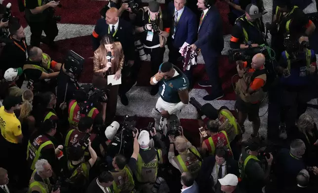Philadelphia Eagles quarterback Jalen Hurts (1) wipes his eyes after the NFL Super Bowl 59 football game against the Kansas City Chiefs, Sunday, Feb. 9, 2025, in New Orleans. (AP Photo/David J. Phillip)