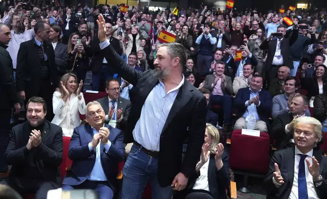 Spanish far-right VOX party leader Santiago Abascal, centre, waves next to European far-right politicians during the Patriots for Europe summit in Madrid, Spain, Saturday, Feb. 8, 2025. Front row from left, Italy's vice Premier Matteo Salvini, Hungarian Prime Minister Viktor Orban, far-right VOX party leader Santiago Abascal, French far-right leader Marine Le Pen and Dutch far right wing politician Geert Wilders.(AP Photo/Paul White)