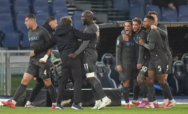 Napoli's Giacomo Raspadori, fourth from right, is congratulated after scoring his side's first goal during a Serie A soccer match between Lazio and Napoli in Rome, Italy, Saturday, Feb. 15, 2025. (AP Photo/Andrew Medichini)