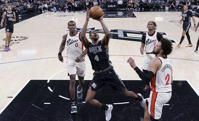 San Antonio Spurs guard De'Aaron Fox (4) shoots over Detroit Pistons guard Cade Cunningham (2) during the second half of an NBA basketball game in Austin, Texas, Friday, Feb. 21, 2025. (AP Photo/Eric Gay)