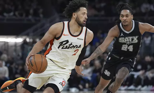 Detroit Pistons guard Cade Cunningham (2) drives around San Antonio Spurs guard Devin Vassell (24) during the first half of an NBA basketball game in Austin, Texas, Friday, Feb. 21, 2025. (AP Photo/Eric Gay)