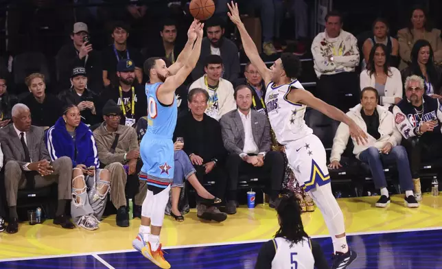 Golden State Warriors guard Stephen Curry makes a 3-point basket during the NBA All-Star basketball game Sunday, Feb. 16, 2025, in San Francisco. (AP Photo/Jed Jacobsohn)