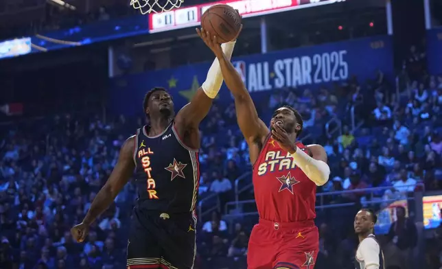 Cleveland Cavaliers guard Donovan Mitchell, right, drives to the basket as Memphis Grizzlies forward Jaren Jackson Jr. defends during the NBA All-Star basketball game Sunday, Feb. 16, 2025, in San Francisco. (AP Photo/Godofredo A. Vásquez)