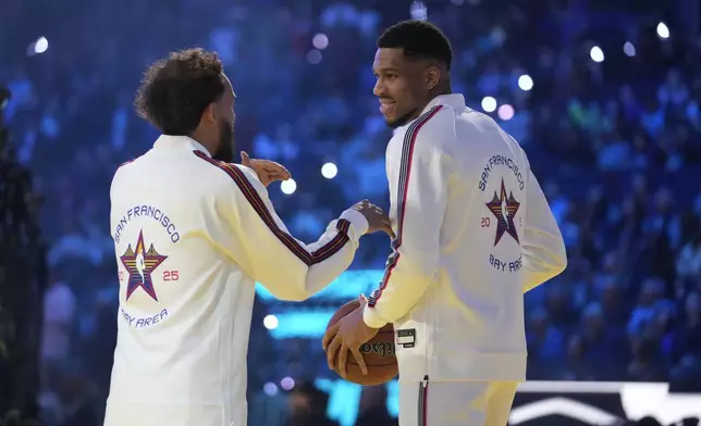 Milwaukee Bucks center Giannis Antetokounmpo talks to Atlanta Hawks guard Trae Young during the NBA All-Star basketball game Sunday, Feb. 16, 2025, in San Francisco. (AP Photo/Godofredo A. Vásquez)