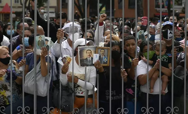 FILE - People gather outside La Candelaria Catholic church associated with Dr. Jose Gregorio Hernandez on the day of his beatification ceremony, in Caracas, Venezuela, April 30, 2021. (AP Photo/Matias Delacroix, File)