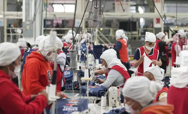 Employees work at a textile factory in Tlaxcala, Mexico, Tuesday, Feb. 4, 2025. (AP Photo/Eduardo Verdugo)