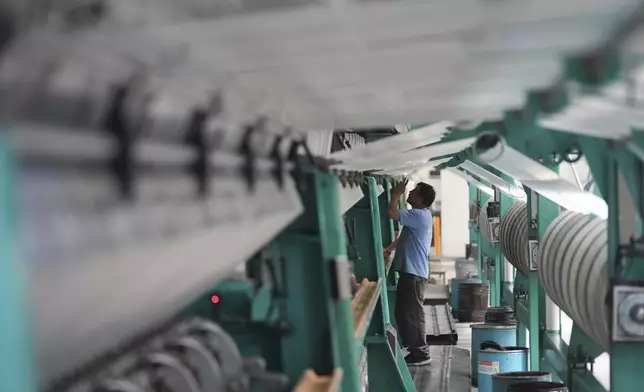 An employee works in a textile factory in Tlaxcala, Mexico, Tuesday, Feb. 4, 2025. (AP Photo/Eduardo Verdugo)