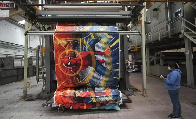 An employee works at a textile factory in Tlaxcala, Mexico, Tuesday, Feb. 4, 2025. (AP Photo/Eduardo Verdugo)