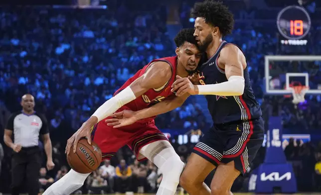 San Antonio Spurs center Victor Wembanyama is defended by Detroit Pistons guard Cade Cunningham during the NBA All-Star basketball game Sunday, Feb. 16, 2025, in San Francisco. (AP Photo/Godofredo A. Vásquez)