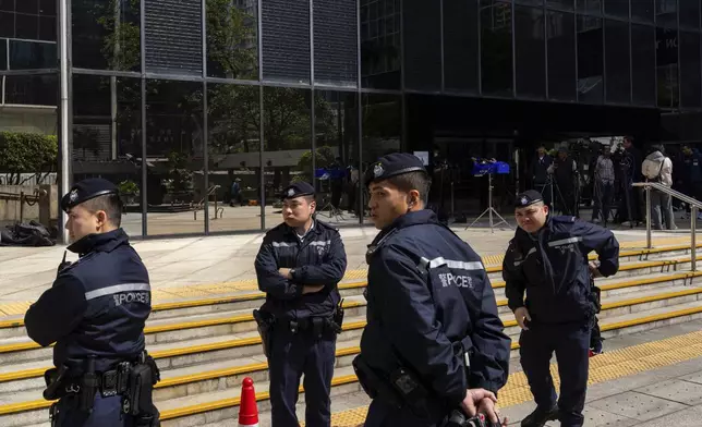 CORRECTS THE YEAR - Police officers stand guard outside the District Court ahead of the sentencing on a riot case involving a former pro-democracy lawmaker Lam Cheuk-ting in Wan Chai, Hong Kong on Thursday, Feb. 27, 2025. (AP Photo/Chan Long Hei)