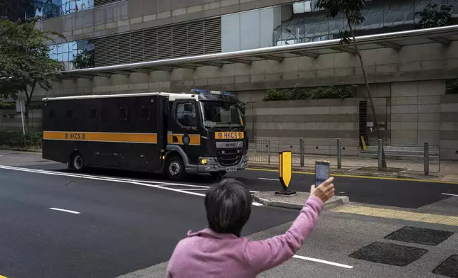 CORRECTS THE YEAR - A supporter waves hand to a Correctional Services prison van as it arrives at the District Court ahead of the sentencing on a riot case involving a former pro-democracy lawmaker Lam Cheuk-ting in Wan Chai, Hong Kong on Thursday, Feb. 27, 2025. (AP Photo/Chan Long Hei)