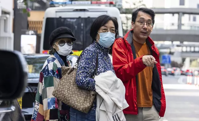 One of the defendants, former pro-democracy lawmaker Lam Cheuk-ting's mother, center, leaves the District Court ahead of the sentencing on a riot case in Wan Chai, Hong Kong on Thursday, Feb. 27, 2025. (AP Photo/Chan Long Hei)