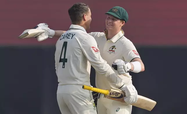 Australia's Alex Carey celebrates his century with Steven Smith during day two of the second test cricket match between Sri Lanka and Australia in Galle , Sri Lanka, Friday, Feb. 7, 2025. (AP Photo/Eranga Jayawardena)