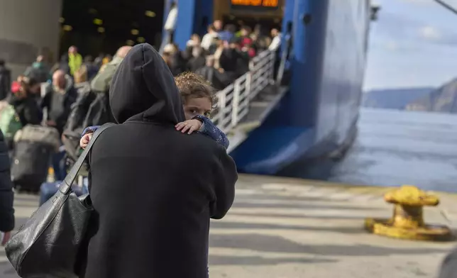 Passengers board a regularly scheduled ferry to Athens' port of Piraeus, after a spike in seismic activity raised concerns about a potentially powerful earthquake in Santorini, southern Greece, Monday, Feb. 3, 2025. (AP Photo/Petros Giannakouris)