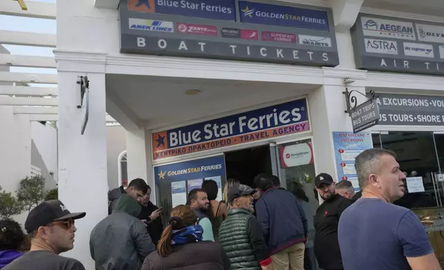 People wait to buy boat and air tickets as Greek authorities are taking emergency measures in response to intense seismic activity on the popular Aegean Sea holiday island of Santorini, southern Greece, Monday, Feb. 3, 2025. (AP Photo/Petros Giannakouris)