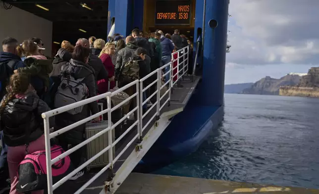 Passengers board a regularly scheduled ferry to Athens' port of Piraeus, after a spike in seismic activity raised concerns about a potentially powerful earthquake in Santorini, southern Greece, Monday, Feb. 3, 2025. (AP Photo/Petros Giannakouris)