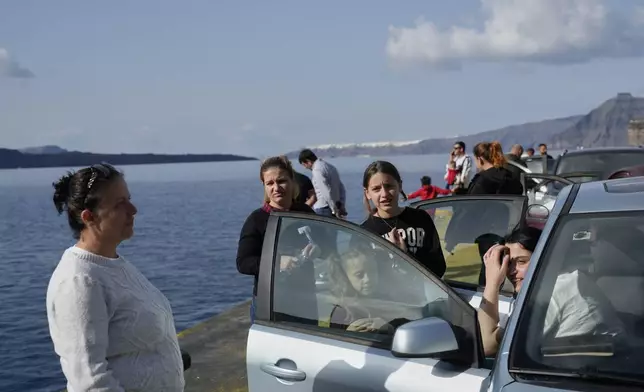 People wait for the arrival of a regularly scheduled ferry to Athens' port of Piraeus, after a spike in seismic activity raised concerns about a potentially powerful earthquake in Santorini, southern Greece, Monday, Feb. 3, 2025. (AP Photo/Petros Giannakouris)