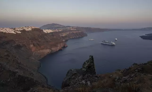 FILE - Ruins of a settlement, including a former Catholic monastery, lie on the rocky promontory of Skaros on the Greek island of Santorini, on June 15, 2022. (AP Photo/Petros Giannakouris, File)