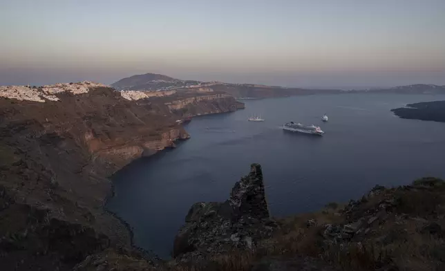 FILE - Ruins of a settlement, including a former Catholic monastery, lie on the rocky promontory of Skaros on the Greek island of Santorini, Wednesday, June 15, 2022. (AP Photo/Petros Giannakouris, File)