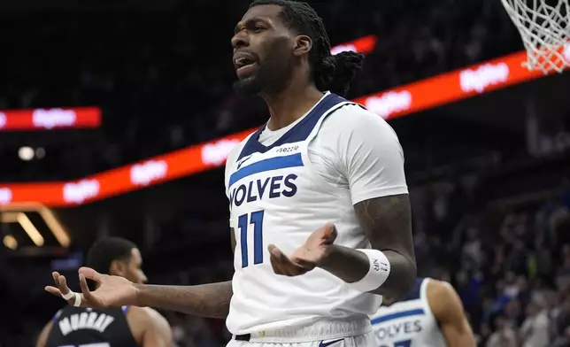 Minnesota Timberwolves center Naz Reid (11) reacts after being called for a foul during the first half of an NBA basketball game against the Sacramento Kings, Monday, Feb. 3, 2025, in Minneapolis. (AP Photo/Abbie Parr)